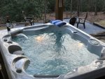 Soak in the delightful hot tub in private, wooded backyard